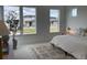 Inviting bedroom showcasing plush carpeting, modern furnishings, and neighborhood views at 710 Belay St, Erie, CO 80516