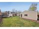View of the house from the backyard, featuring a covered patio and a detached garage at 2830 Forest St, Denver, CO 80207