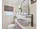 Modern bathroom featuring a unique vessel sink, stylish fixtures, and neutral tones at 2830 Forest St, Denver, CO 80207