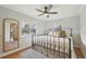 Cozy bedroom with a wrought iron bed frame, neutral decor, hardwood floors, and a ceiling fan at 2830 Forest St, Denver, CO 80207