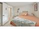 Cozy bedroom with pastel colored bedspread, decorative throw pillows and a charming white shelving unit at 2830 Forest St, Denver, CO 80207