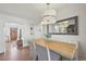 Bright dining area with a wood table, upholstered bench, modern lighting, and beautiful hardwood floors at 2830 Forest St, Denver, CO 80207