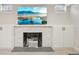 Elegant fireplace featuring white tiling, stylish mantel, built-in cabinets, and a modern design at 2830 Forest St, Denver, CO 80207