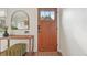Cozy foyer featuring hardwood floors, a stylish mirror, and a charming wooden door, creating a warm entrance at 2830 Forest St, Denver, CO 80207