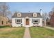 Charming home featuring a well-manicured lawn, a brick exterior, dormer windows, and an inviting front entrance at 2830 Forest St, Denver, CO 80207