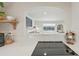 Bright kitchen showcases a white quartz countertop, tile backsplash, and an open view into the living room at 2830 Forest St, Denver, CO 80207