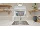 Bright kitchen with a stainless steel sink, quartz countertops, open shelving, and ample natural light at 2830 Forest St, Denver, CO 80207