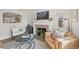 Bright living room with hardwood floors, fireplace, archway, and comfortable leather seating at 2830 Forest St, Denver, CO 80207