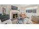 Bright living room with hardwood floors, fireplace, and comfortable leather seating at 2830 Forest St, Denver, CO 80207