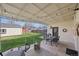 Charming covered patio with outdoor dining set, grassy yard, and a relaxing atmosphere at 2830 Forest St, Denver, CO 80207