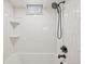 Shower over tub with white subway tile and sleek black fixtures at 2830 Forest St, Denver, CO 80207