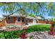 Backyard features a brick exterior, lush green lawn, and mature shade trees at 2072 Skylark Ct, Longmont, CO 80503