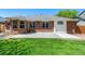 Exterior view of home with brick siding, large concrete patio and lush green lawn at 2072 Skylark Ct, Longmont, CO 80503