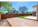 Spacious backyard featuring a large patio, green lawn, and wood fence at 2072 Skylark Ct, Longmont, CO 80503