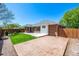 This backyard offers a stamped concrete patio, green grass, and privacy fencing at 2072 Skylark Ct, Longmont, CO 80503