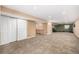 Finished basement area with carpet flooring, recessed lighting, storage closets, and a dedicated workout area at 2072 Skylark Ct, Longmont, CO 80503