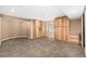 Basement area with built-in wooden cabinets, carpeted flooring, and a window for natural light at 2072 Skylark Ct, Longmont, CO 80503