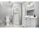 Bathroom featuring a tiled glass shower, toilet, white vanity with countertop, and modern lighting at 2072 Skylark Ct, Longmont, CO 80503