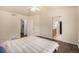 Bright bedroom features ceiling fan, dark wood floors, and ensuite bathroom and walk-in closet access at 2072 Skylark Ct, Longmont, CO 80503