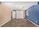 Basement bedroom with carpet and painted blue and beige walls, complete with a window and closet at 2072 Skylark Ct, Longmont, CO 80503