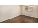 Neutral bedroom with dark wood floors and sunlit window facing the outside at 2072 Skylark Ct, Longmont, CO 80503