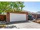Close-up of the exterior showing the attached garage and landscaping at 2072 Skylark Ct, Longmont, CO 80503