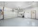 Spacious garage with epoxy flooring, ample lighting, and room for multiple vehicles and storage at 2072 Skylark Ct, Longmont, CO 80503