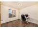 A home office featuring hardwood floors and a large window overlooking the yard at 2072 Skylark Ct, Longmont, CO 80503