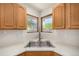 Bright kitchen with stainless steel sink and faucet, and double windows looking out to the backyard at 2072 Skylark Ct, Longmont, CO 80503