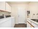 Laundry room with washer, dryer, cabinets, sink, and a door to outside at 2072 Skylark Ct, Longmont, CO 80503