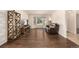 Spacious living room featuring hardwood floors, a bay window, and a comfortable leather couch at 2072 Skylark Ct, Longmont, CO 80503