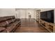 An inviting living room featuring hardwood floors and a comfortable leather couch at 2072 Skylark Ct, Longmont, CO 80503