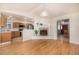 Living room with fireplace, hardwood floors, and view into the kitchen at 2072 Skylark Ct, Longmont, CO 80503