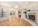 Bright living room featuring hardwood floors, a fireplace, and a view into the kitchen area at 2072 Skylark Ct, Longmont, CO 80503