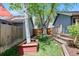 Landscaped backyard featuring a lush green lawn and beautiful trees, creating a serene outdoor space at 7659 S Rosemary Cir, Englewood, CO 80112