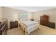 Cozy bedroom with neutral tones, a comfortable bed, and ample storage furniture at 7659 S Rosemary Cir, Englewood, CO 80112