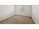 Minimalist bedroom with neutral carpeting, white walls, and natural light from a window at 7659 S Rosemary Cir, Englewood, CO 80112