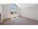 Large bonus room with carpeted floors and tall windows providing ample natural light at 7659 S Rosemary Cir, Englewood, CO 80112