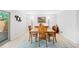 Well-lit dining room with wood table and chairs creates an inviting space for meals at 7659 S Rosemary Cir, Englewood, CO 80112
