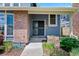 A welcoming front porch with brick accents invites you into this beautiful residence at 7659 S Rosemary Cir, Englewood, CO 80112