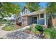 Inviting home with lush landscaping and a charming blue exterior provides great curb appeal at 7659 S Rosemary Cir, Englewood, CO 80112