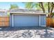 Detached garage with a blue door, providing secure parking and additional storage at 7659 S Rosemary Cir, Englewood, CO 80112