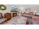 Elegant living room showcases brick fireplace, plush seating, and stylish decor elements at 7659 S Rosemary Cir, Englewood, CO 80112