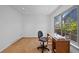 Bright office space featuring natural light from a large window and neutral carpeting at 7659 S Rosemary Cir, Englewood, CO 80112
