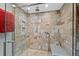 Modern bathroom shower featuring stone-look walls and a built-in bench at 7659 S Rosemary Cir, Englewood, CO 80112