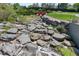 Natural rock water feature with landscaping adds tranquility to the community at 7659 S Rosemary Cir, Englewood, CO 80112