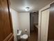 Compact bathroom with a toilet, shower, and storage at 8995 E Cornell Ave, Denver, CO 80231