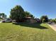 View of a charming single-story home with a lush front lawn on a sunny day at 8995 E Cornell Ave, Denver, CO 80231