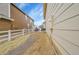 Backyard with a gravel path and paved patio area with grill and seating between two houses at 23601 E Mississippi Cir, Aurora, CO 80018