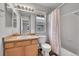 Bathroom with vanity, a shower/tub combo with curtain, and window at 23601 E Mississippi Cir, Aurora, CO 80018